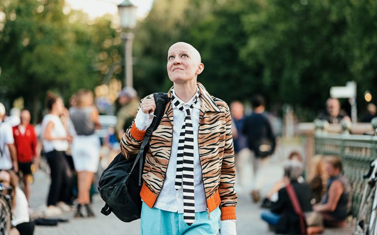 Young woman walking on a crowded bridge