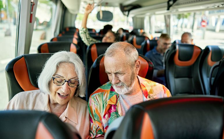 Retired tourists in 60s and 70s onboard motor coach