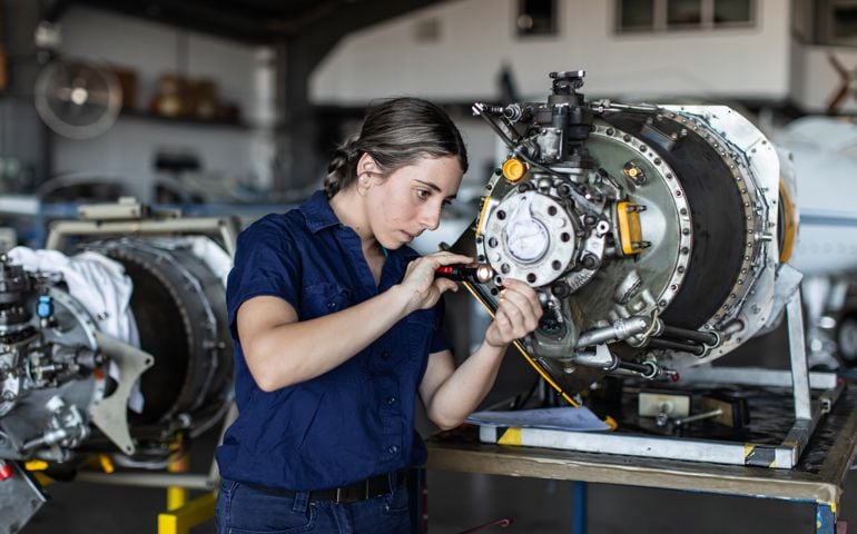 Real life young female aircraft engineer apprentice at work