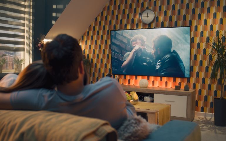 Couple on sofa watching action movie