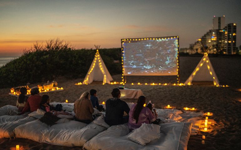 Group of people watching a movie at the outdoors cinema
