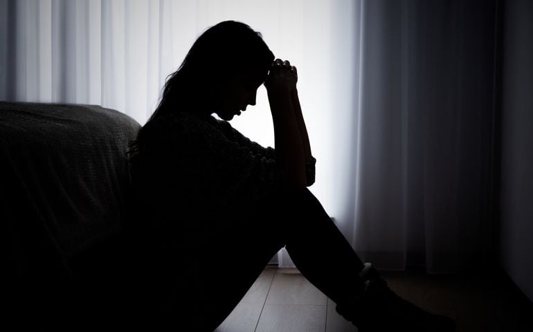 Depressed woman. Sadness and headache concept