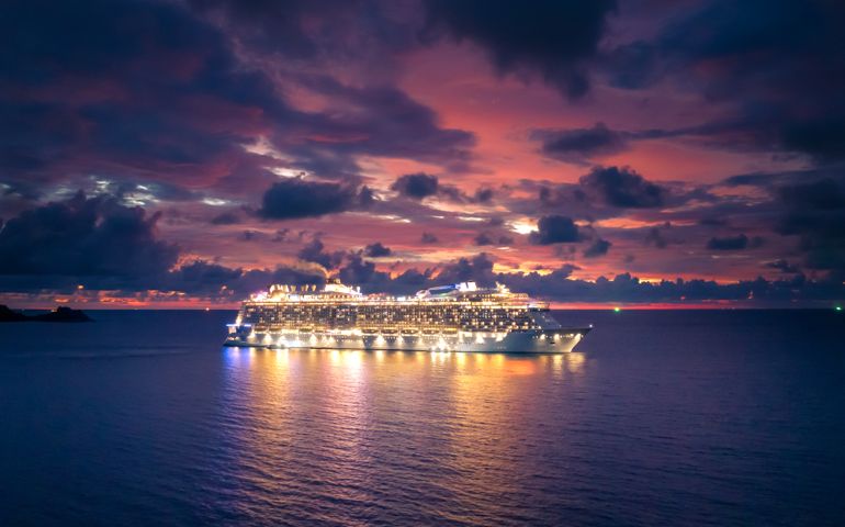 Cruise ship at sea aerial view with dramatic clouds at sunset in the Andaman Sea, Phuket, Thailand