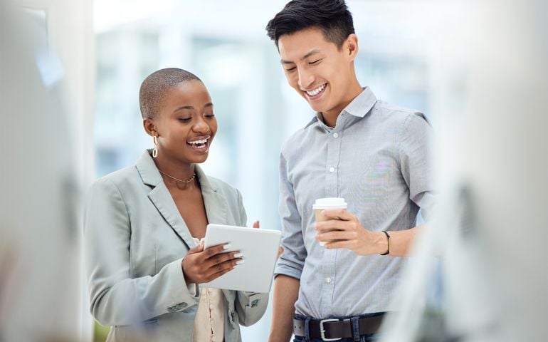 Tablet, smile and employees talking about business on the internet, online partnership and reading an email together at work. Marketing workers with idea for creative collaboration on technology