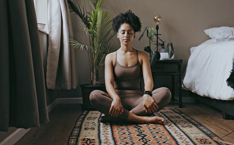 Zen, relax and mediation with black woman and yoga in bedroom for calm, peace and morning routine. Wellness, breathing and balance with health girl training at home for spiritual, healing and energy