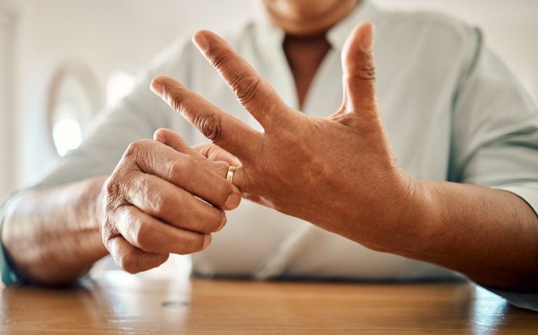 Divorce, ring and hand of old woman at home for separation, breakup and conflict. Marriage problem, relationship issues and finish with wife finger and decision for change, disagree and leave