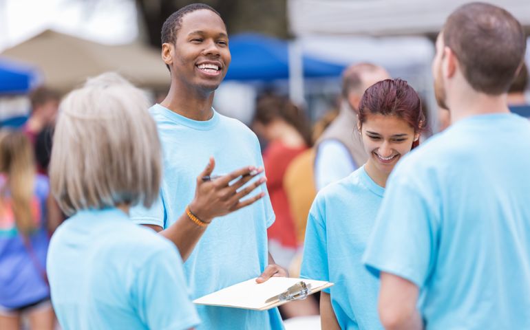 Volunteer leader giving instructions at outdoor festival or market