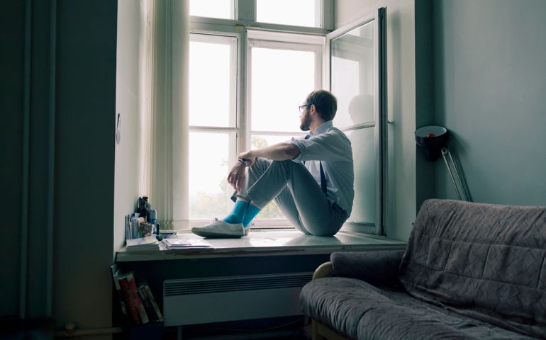 Man sitting on window sill