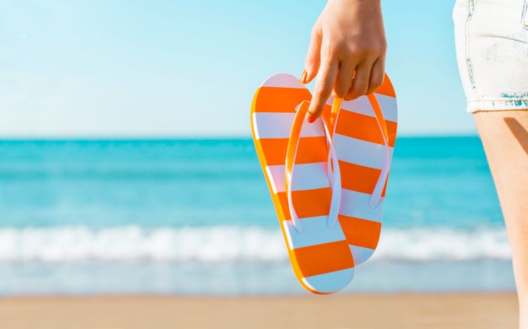 sandals in hand