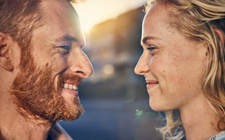 Young couple smiling at each other, close up