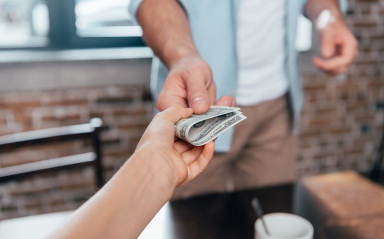 cropped shot of dad giving pocket money to daughter