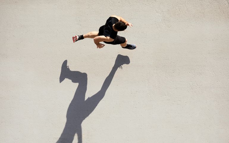 Sprinter seen from above with shadow and copy space.
