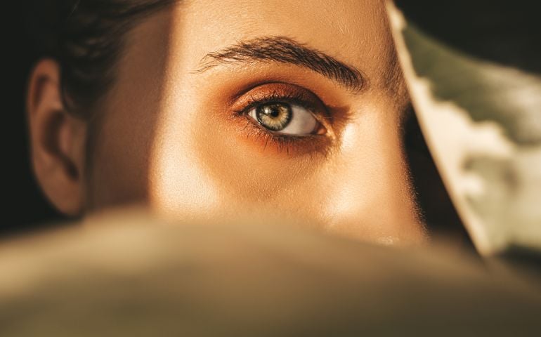 Beautiful woman behind leaves