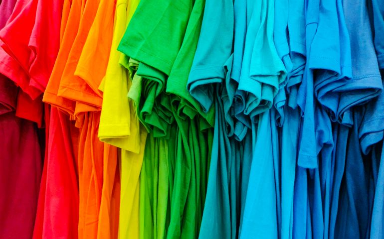 Lots of Bright -Rainbow colors display- T-shirts hanging On Rack