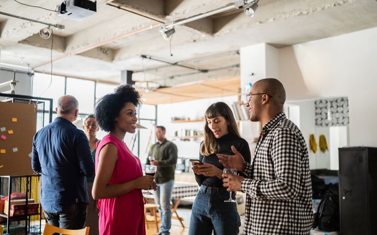 Colleagues talking after work at a coworking