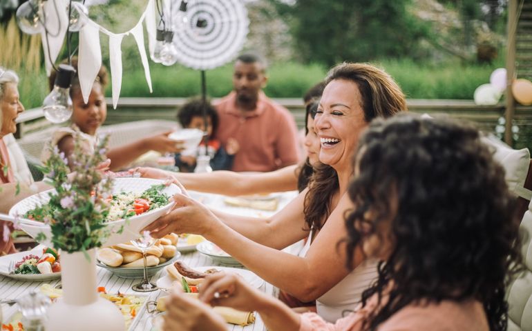 Cheerful family in dinner party at backyard