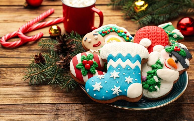 Delicious homemade Christmas cookies and festive decor on wooden table