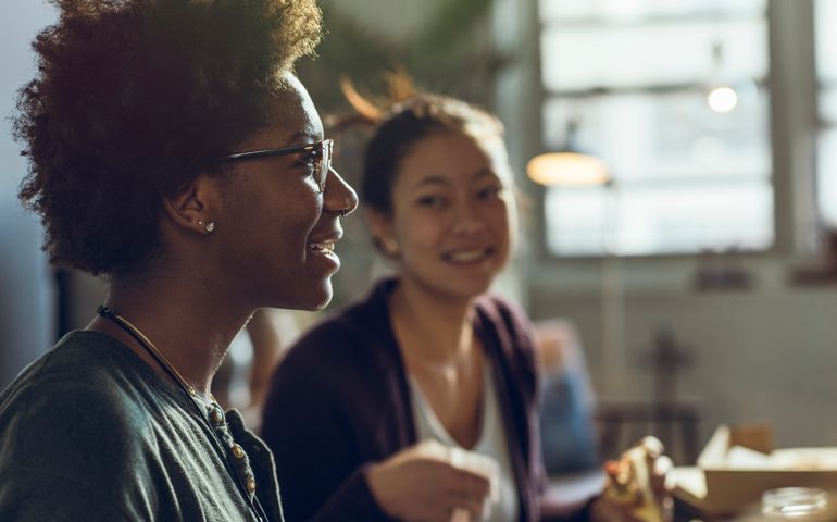 Female friends spending leisure time while talking at home