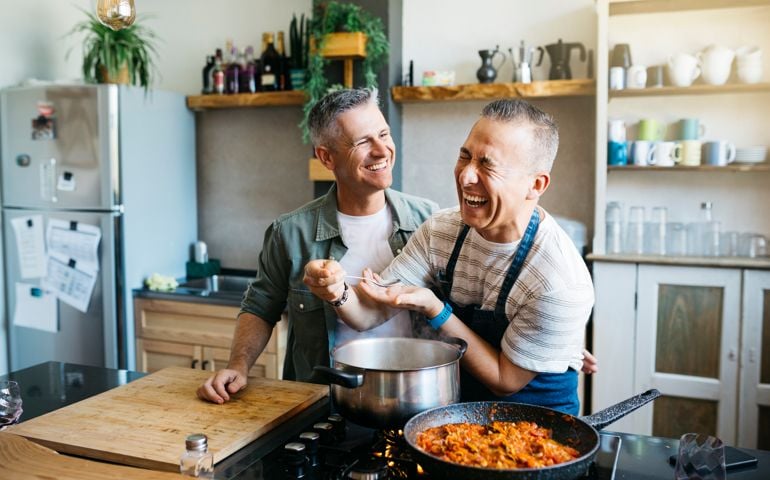 Gay couple having fun while cooking