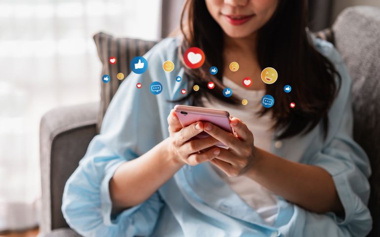 Young woman with drinks using mobile phone and relaxing at home, Modern lifestyle and social media concept.