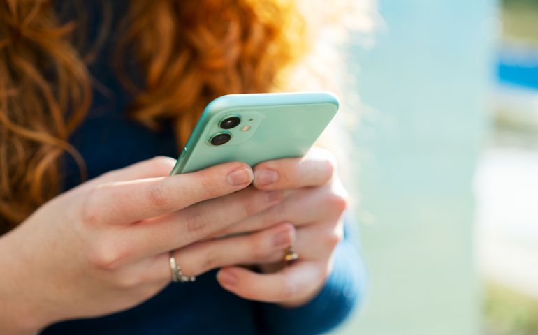 Close up or woman using smart phone