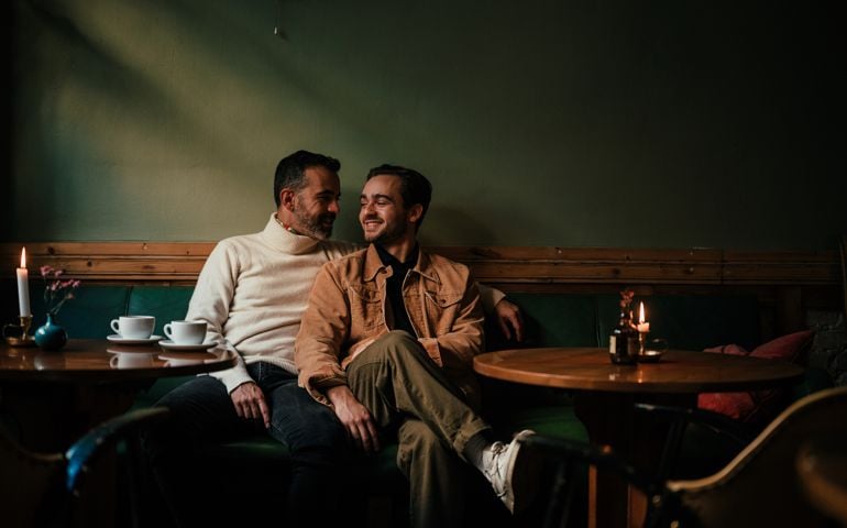 Gay male couple on a date in a cafe