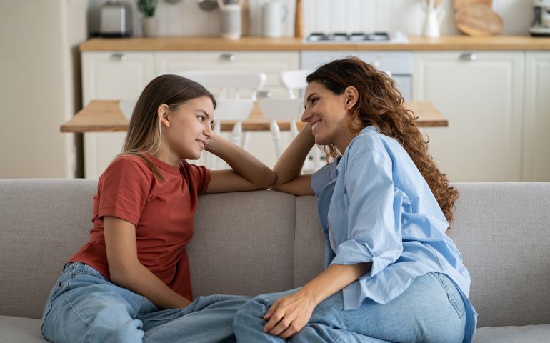 Loving mother listening to daughter with empathy and understanding, child sharing secrets with mom