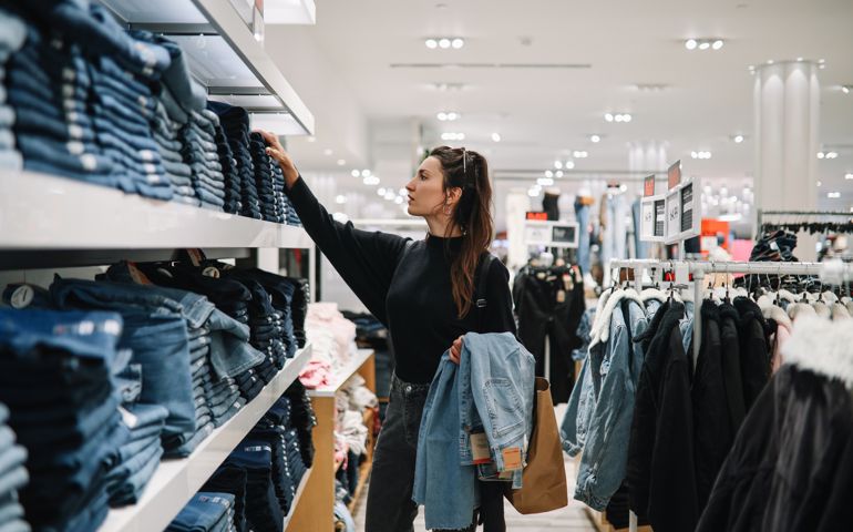 woman shopping denim jeans in a clothing store