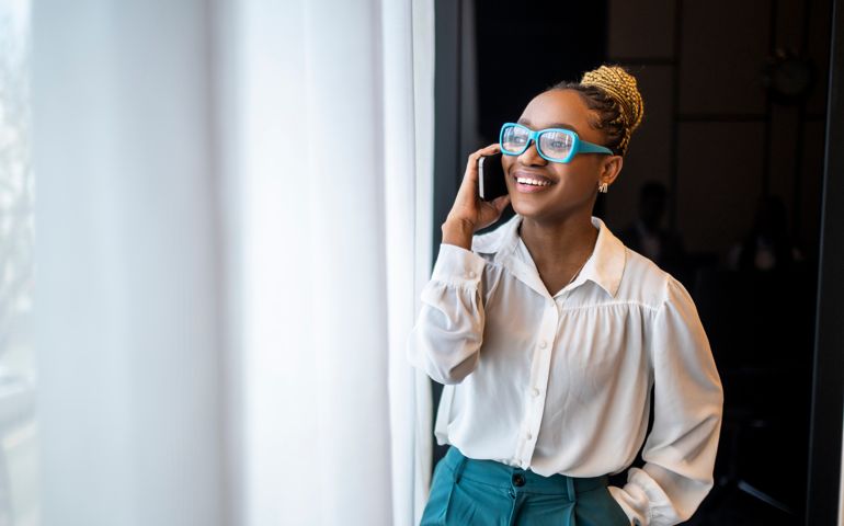 Portrait of a smiling black female entrepreneur talking on the phone