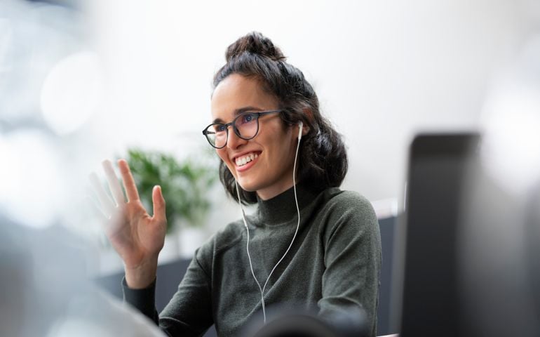 Businesswoman waving hand