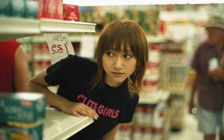 Young woman in supermarket, looking to side