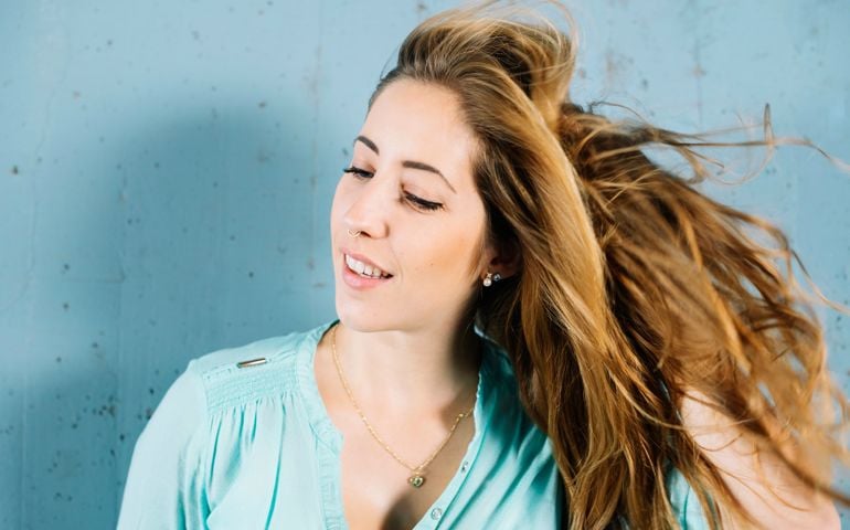 Young beautiful woman shaking blond hair
