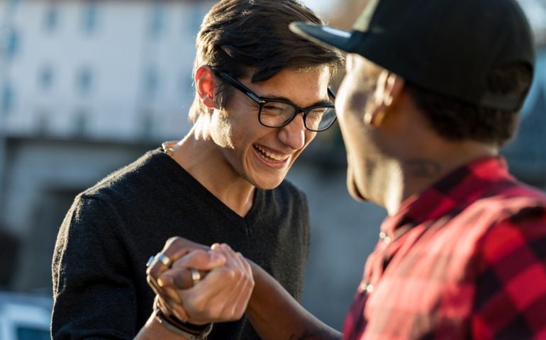 good friends joking about their secret handshake
