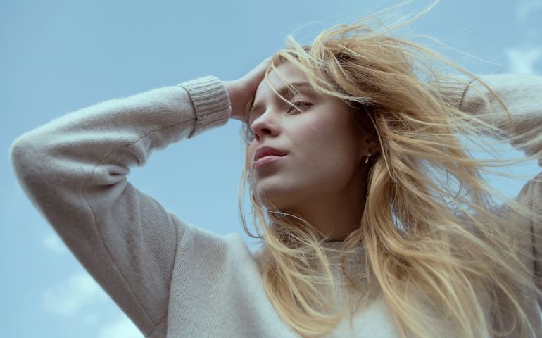Blonde girl breathing fresh air, outdoors