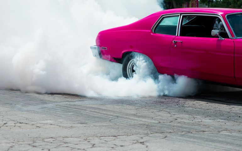 Car burning out and creating smoke.