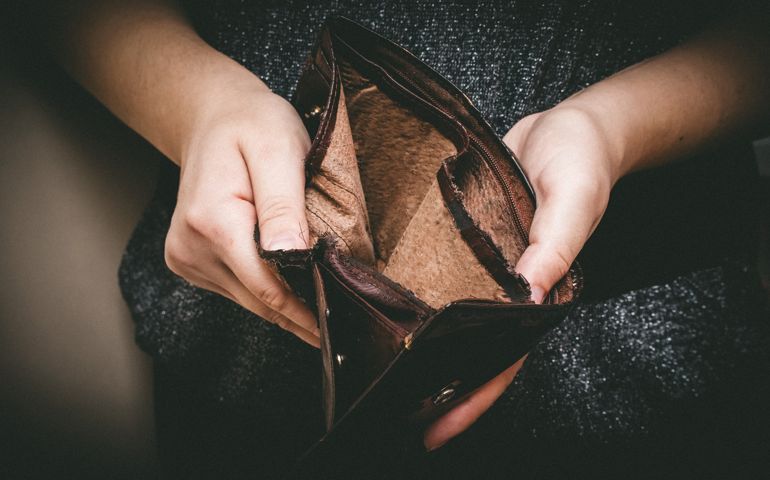 Old empty wallet in the hands .Vintage empty purse in hands of women . Poverty concept, Retirement. Special toning