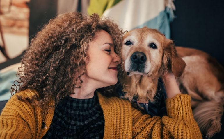 Woman cuddling with her dog