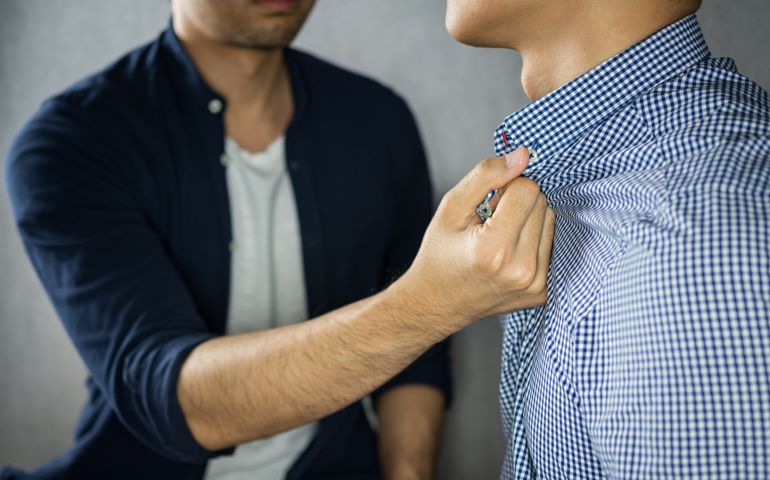 Man grab other by the collar, having argument