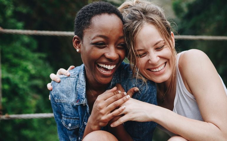 Happy friends holding each other