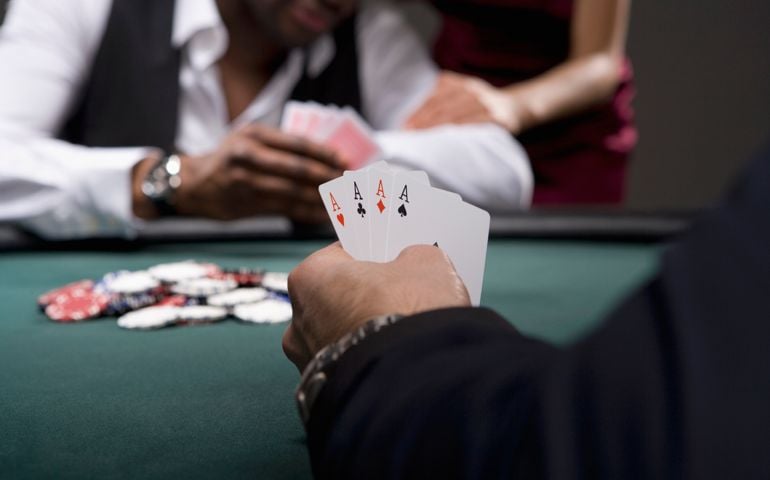Man with four aces in casino