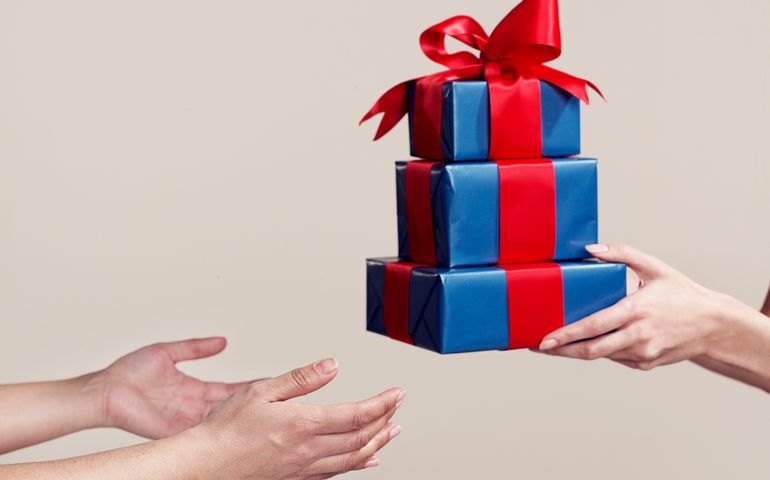 Two people exchanging gifts, close-up of hands