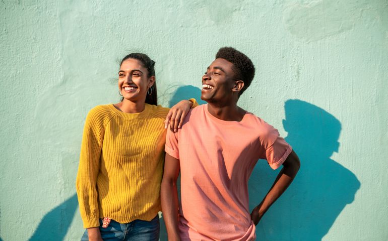 Portrait of two smiling couple looking away.
