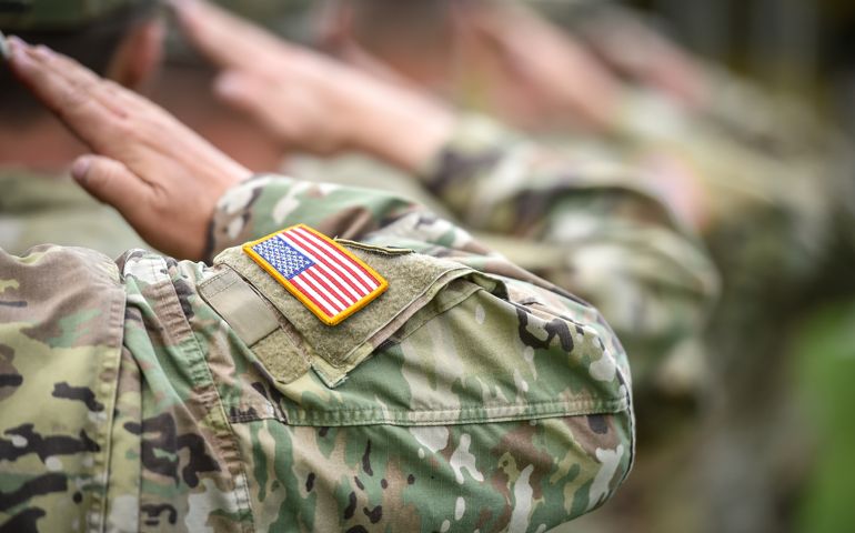 Detail shot with american flag on soldier uniform, giving the honor salute during military ceremony