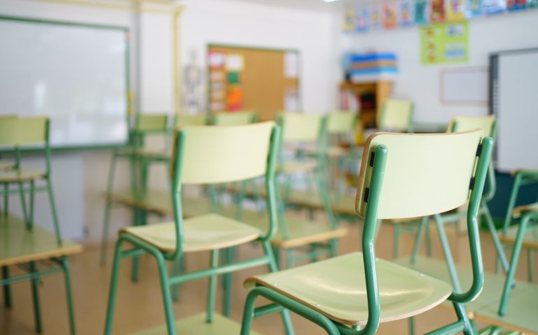Close-up of a chair on a student's desk inside a classroom in a secondary school.