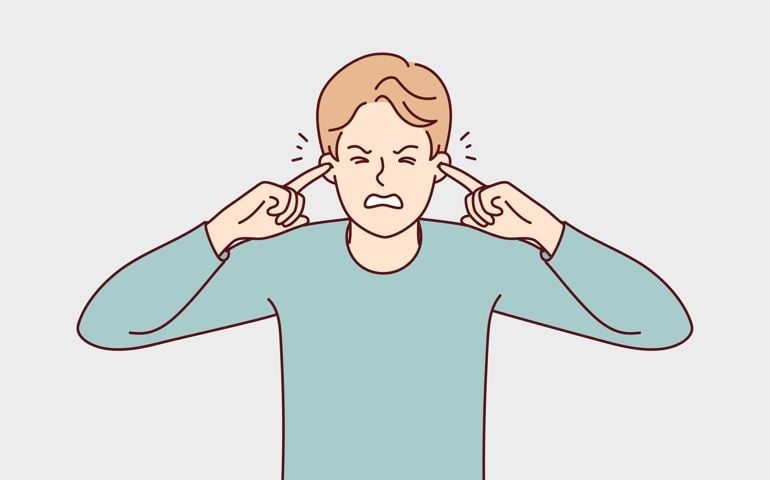 Unhappy man close ears suffer from noise