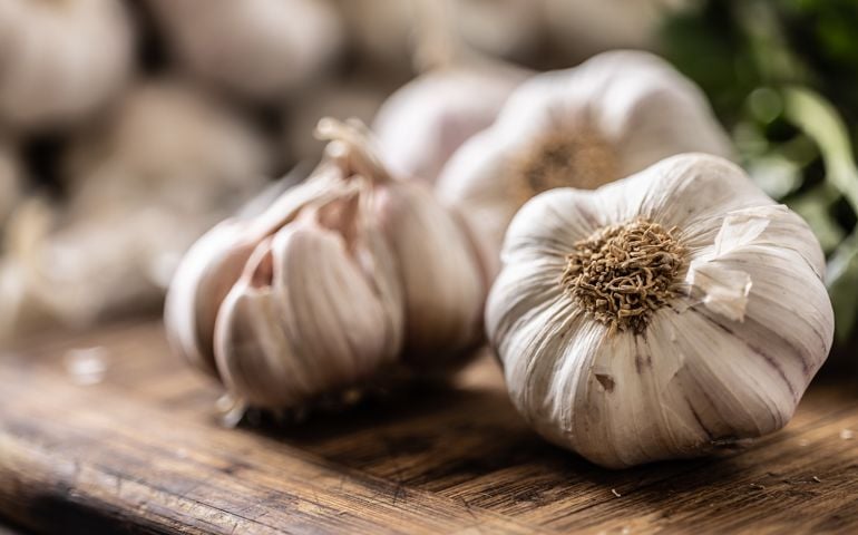 Organic garlic unpeeled ready to be used for cooking in the kitchen.
