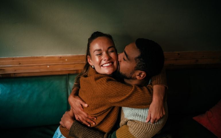 Young couple hugging in a cafe