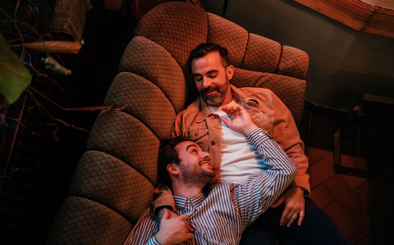 Gay couple lying on a couch