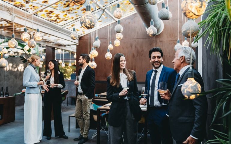 Business people are talking together during a teambuilding event in a luxury restaurant
