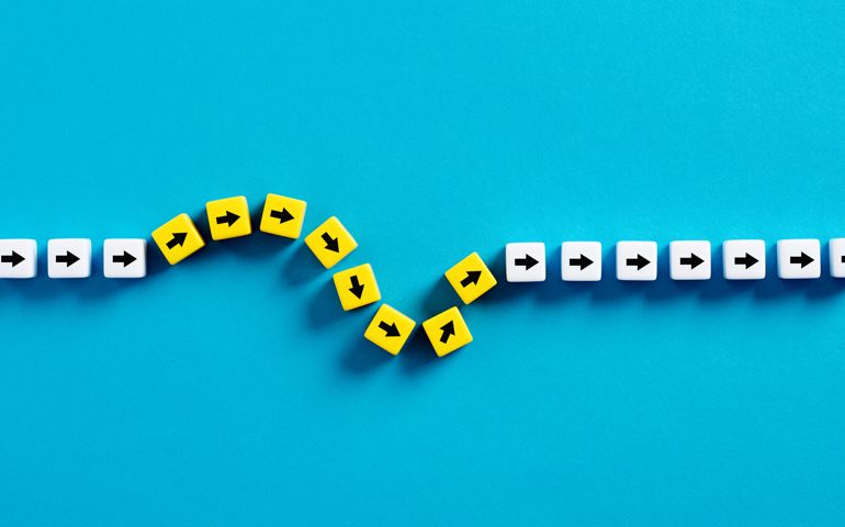 Flexibility and adaptation concept. Arrows on cubes following a flexible path.